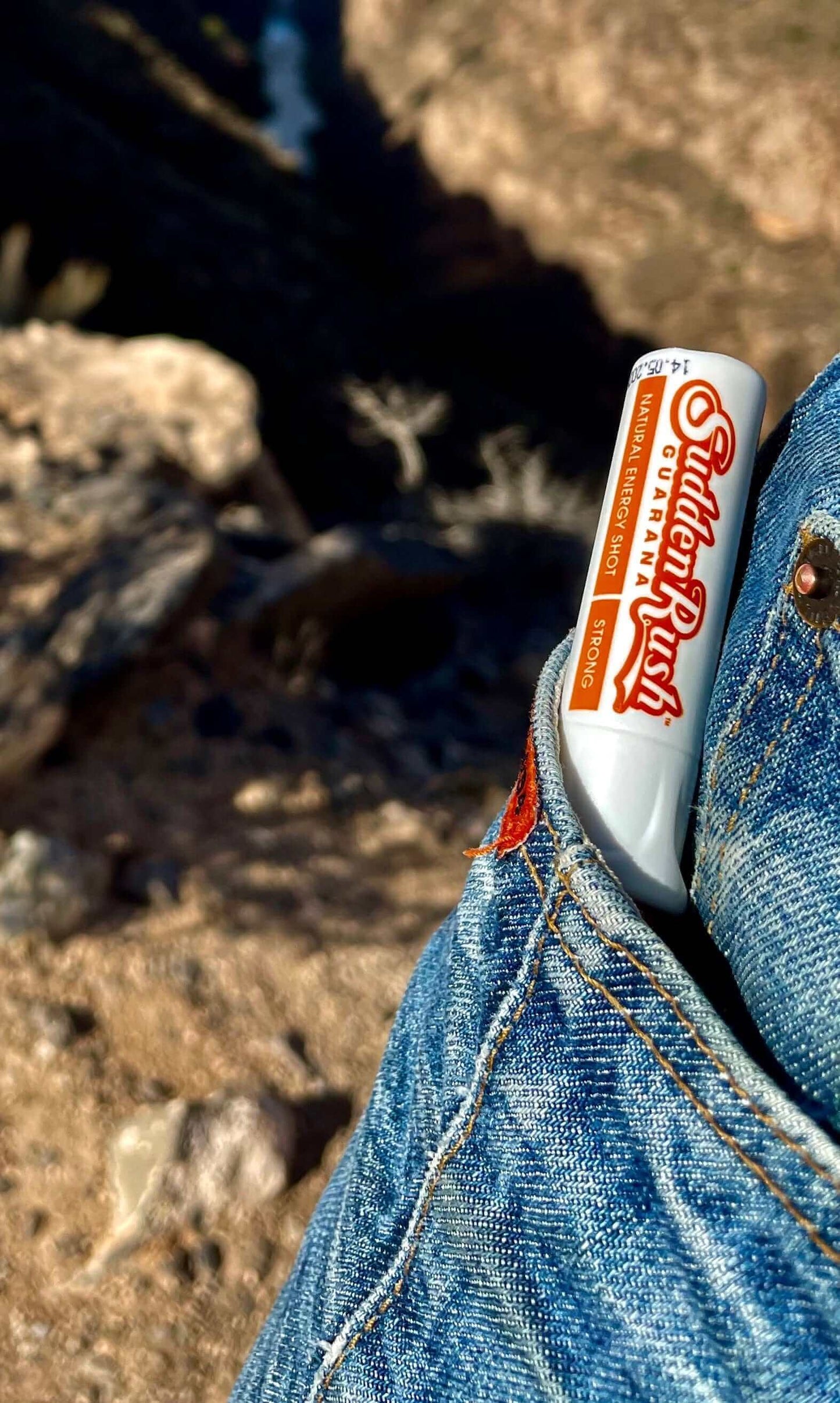 Brown Guarana Energy Shot by SuddenRush in denim pocket, perfect for on-the-go natural caffeine boost